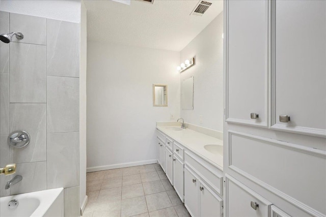1336 Beagle Rd, Orange, TX 77632 - full bathroom with double vanity, tile patterned floors, bathtub / shower combination, and a textured ceiling