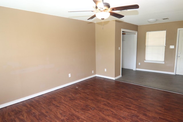 unfurnished room with ceiling fan and dark wood-type flooring