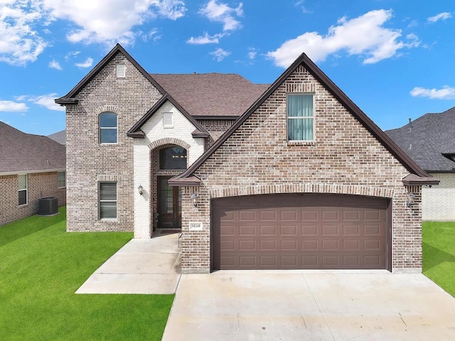 10340 Dominion Ranch Dr, Port Arthur, TX 77640 - french country inspired facade with brick siding, a front yard, roof with shingles, and driveway