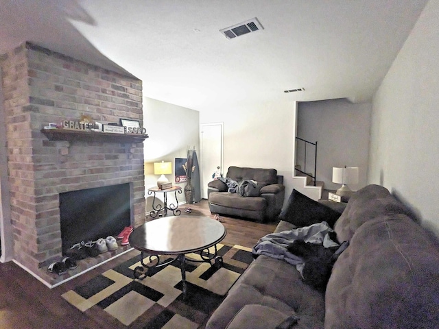 living room featuring wood-type flooring and a fireplace