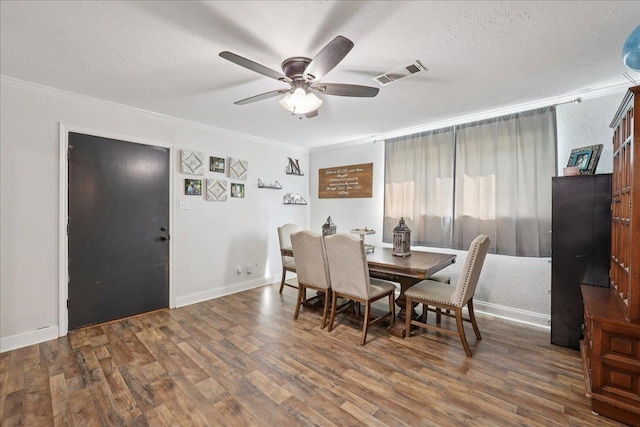1407 N 15th St, Nederland, TX 77627 - dining room featuring ornamental molding, wood finished floors, ceiling fan, baseboards, and a textured ceiling