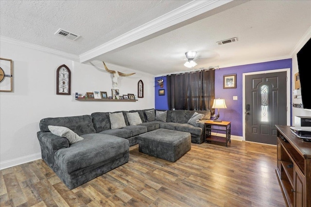 1407 N 15th St, Nederland, TX 77627 - living room featuring crown molding, a textured ceiling, wood finished floors, and baseboards