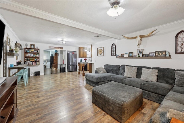 1407 N 15th St, Nederland, TX 77627 - living room with crown molding, wood finished floors, ceiling fan, and a textured ceiling