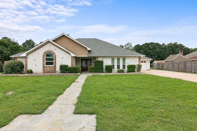 ranch-style house featuring a front yard and a garage