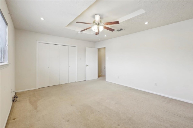 unfurnished bedroom with a closet, visible vents, carpet flooring, and baseboards