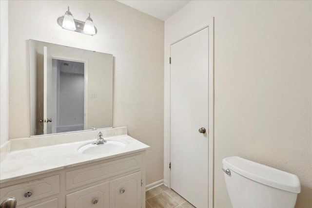 bathroom featuring toilet and vanity