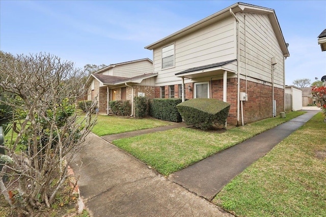 traditional home with brick siding and a front yard