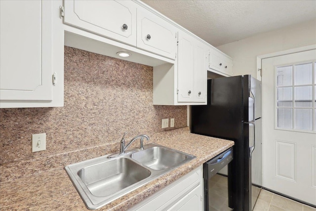 kitchen with backsplash, dishwasher, light countertops, white cabinetry, and a sink