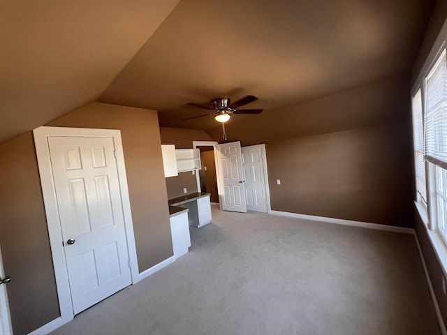 bonus room with ceiling fan, light carpet, and lofted ceiling