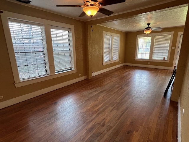 spare room featuring hardwood / wood-style floors, ceiling fan, and crown molding