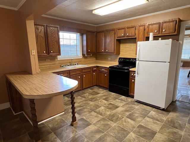 kitchen with tasteful backsplash, black electric range oven, sink, and white fridge