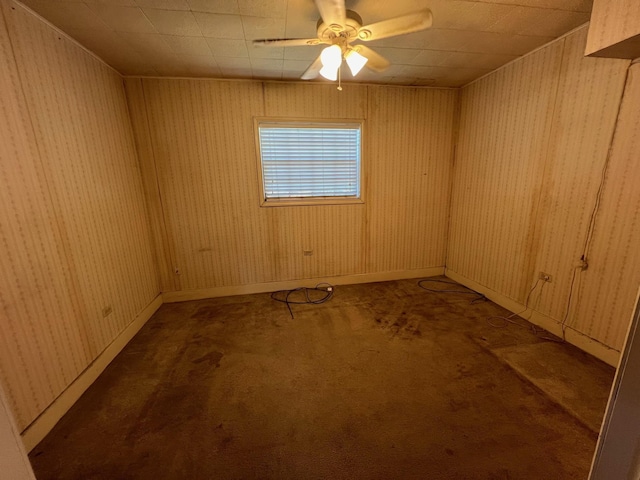 unfurnished room with dark carpet and ceiling fan