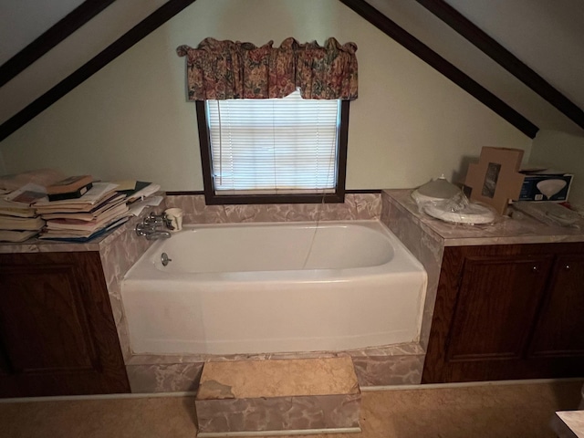 bathroom with lofted ceiling and a bath