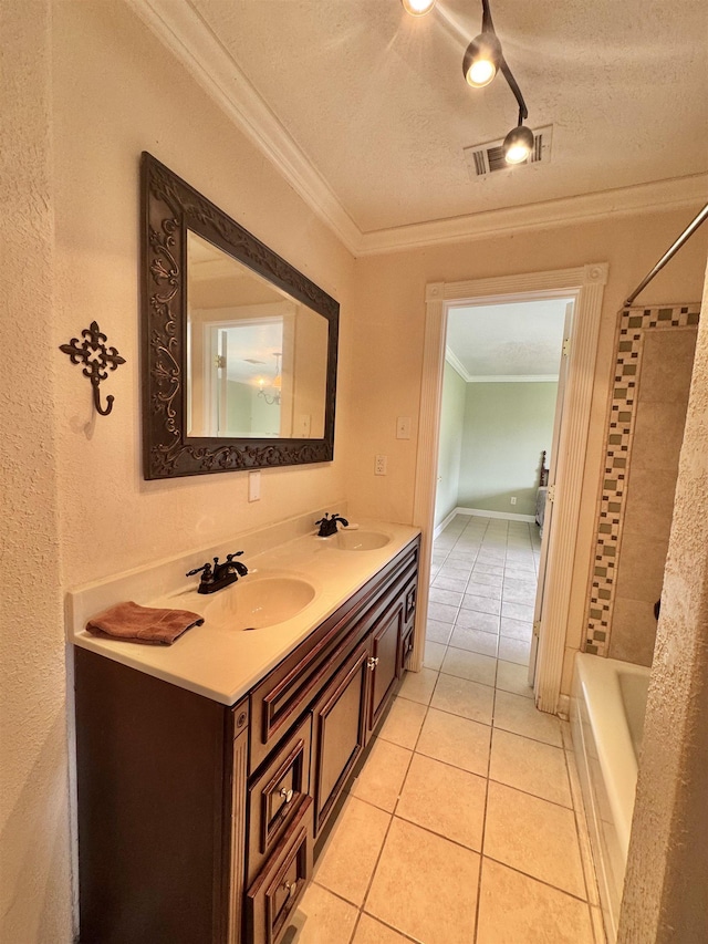 bathroom featuring tile patterned flooring, a sink, a textured ceiling, and ornamental molding