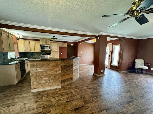 kitchen featuring decorative backsplash, a ceiling fan, crown molding, dark countertops, and appliances with stainless steel finishes
