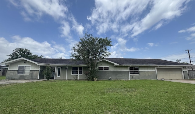 ranch-style house featuring an attached garage, concrete driveway, a front lawn, and brick siding