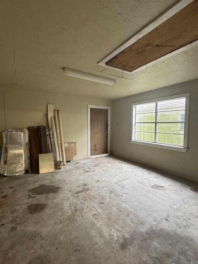 unfurnished room featuring concrete floors