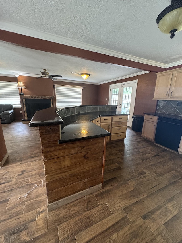 kitchen with crown molding, dark countertops, a textured ceiling, french doors, and dark wood-type flooring