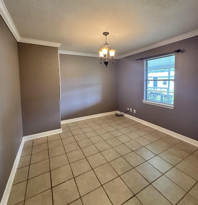 empty room featuring baseboards, ornamental molding, a textured ceiling, and a chandelier