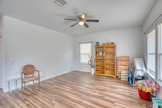 227 County Road 852, Buna, TX 77612 - sitting room featuring light wood finished floors, a ceiling fan, and baseboards