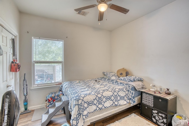 227 County Road 852, Buna, TX 77612 - bedroom with wood finished floors, baseboards, and a ceiling fan