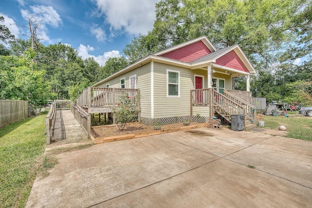 227 County Road 852, Buna, TX 77612 - view of front of house featuring stairway, a deck, crawl space, and a patio area