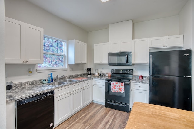 227 County Road 852, Buna, TX 77612 - kitchen featuring black appliances, white cabinets, light wood-style floors, and a sink