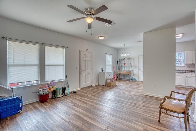 227 County Road 852, Buna, TX 77612 - living area with a ceiling fan, light wood-style flooring, and baseboards
