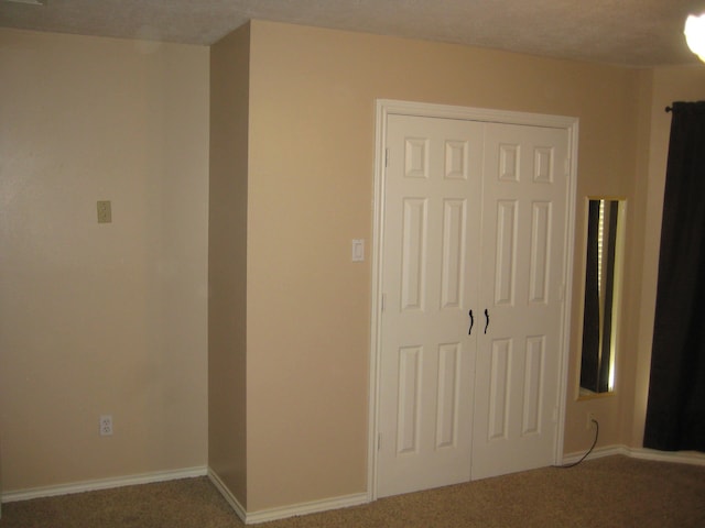 unfurnished bedroom with carpet flooring and a closet