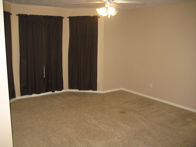 carpeted empty room with ceiling fan