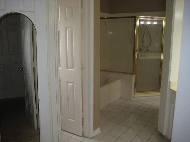 bathroom featuring tile patterned flooring and plus walk in shower