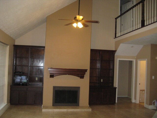 unfurnished living room with ceiling fan, light tile patterned flooring, and high vaulted ceiling