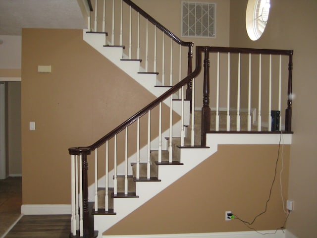 stairway featuring wood-type flooring