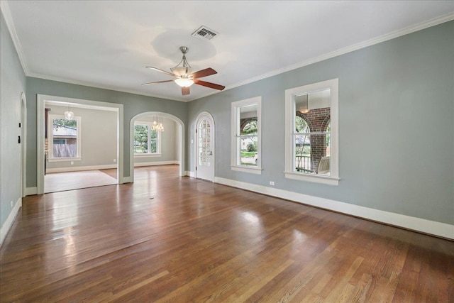 145 Manor St, Beaumont, TX 77706 - empty room with arched walkways, wood finished floors, ceiling fan, a chandelier, and crown molding