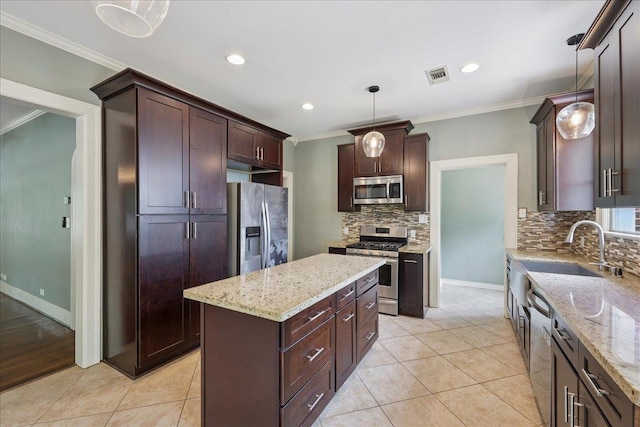 145 Manor St, Beaumont, TX 77706 - kitchen featuring appliances with stainless steel finishes, crown molding, decorative backsplash, light stone counters, and light tile patterned flooring
