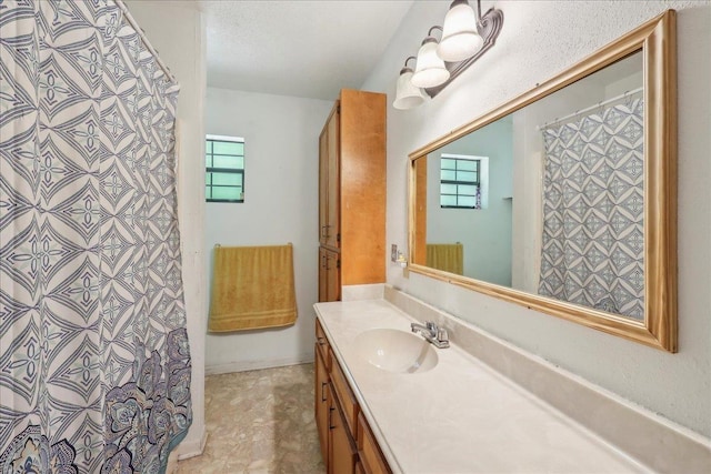 full bathroom featuring vanity, curtained shower, and a healthy amount of sunlight