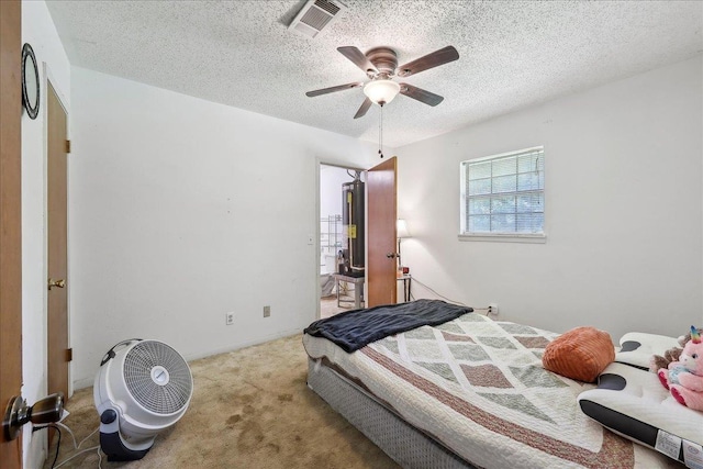 bedroom with a textured ceiling, carpet flooring, ceiling fan, and visible vents