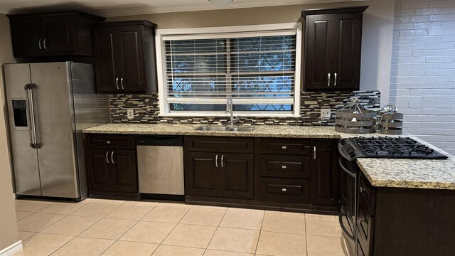 kitchen featuring sink, light tile patterned floors, tasteful backsplash, dark brown cabinets, and stainless steel appliances