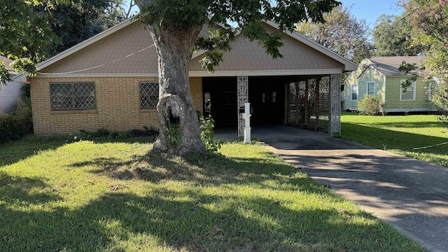 view of front of property with a front lawn and a carport