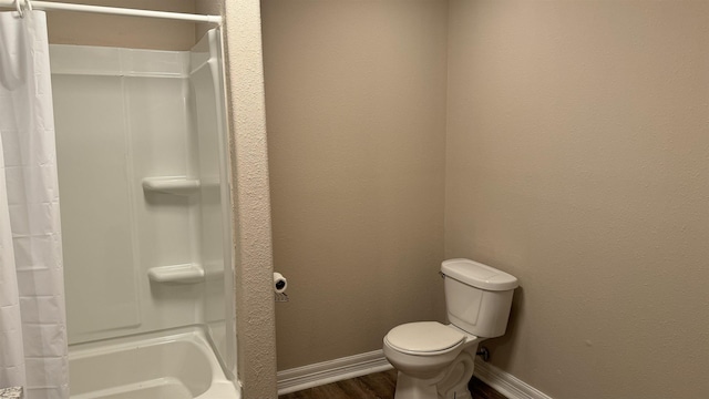 bathroom with hardwood / wood-style floors, toilet, and shower / bath combo