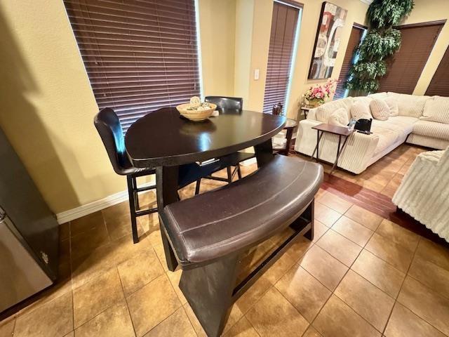 9265 N Sage, Beaumont, TX 77713 - dining room with tile patterned flooring and baseboards