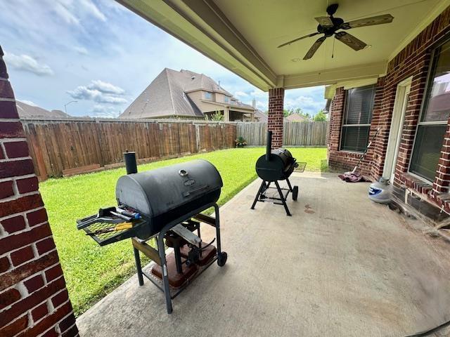 9265 N Sage, Beaumont, TX 77713 - fenced backyard featuring a ceiling fan, a patio area, and grilling area