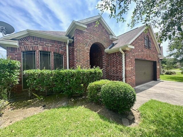9265 N Sage, Beaumont, TX 77713 - view of front of property featuring brick siding and concrete driveway