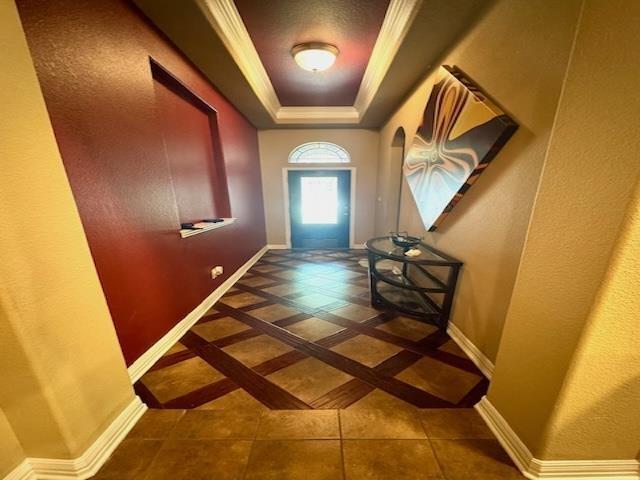 9265 N Sage, Beaumont, TX 77713 - entryway with a tray ceiling, tile patterned flooring, arched walkways, and ornamental molding