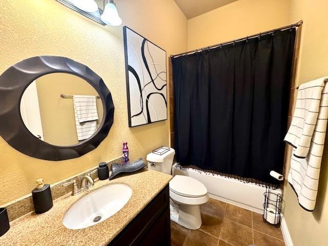 9265 N Sage, Beaumont, TX 77713 - full bathroom with vanity, tile patterned flooring, and shower / tub combo with curtain