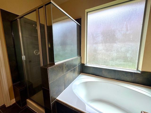 9265 N Sage, Beaumont, TX 77713 - bathroom featuring a stall shower and a bath