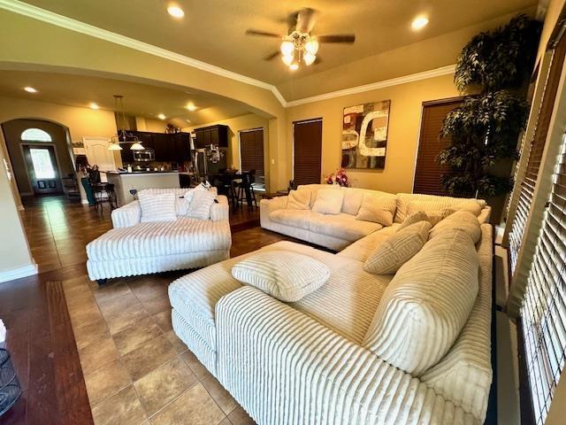 9265 N Sage, Beaumont, TX 77713 - living area with arched walkways, a ceiling fan, ornamental molding, light tile patterned flooring, and recessed lighting