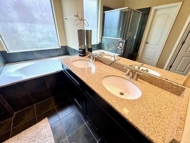 9265 N Sage, Beaumont, TX 77713 - full bath with a bath, tile patterned flooring, a shower stall, and double vanity