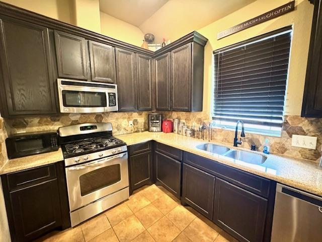 9265 N Sage, Beaumont, TX 77713 - kitchen with stainless steel appliances, light countertops, tasteful backsplash, and light tile patterned floors