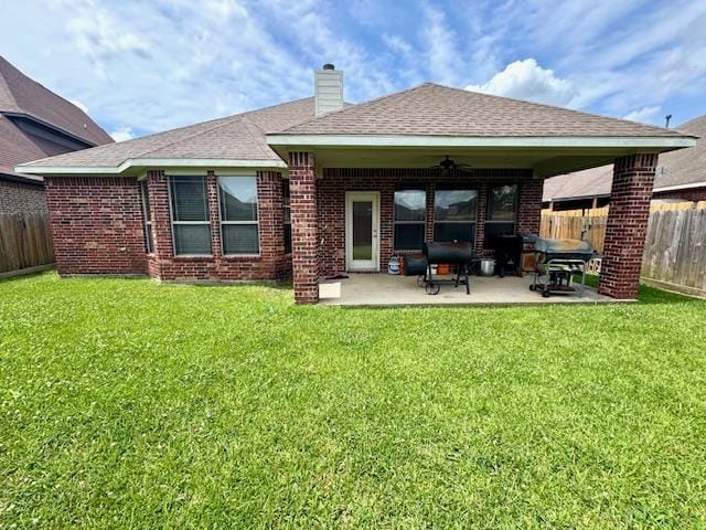 9265 N Sage, Beaumont, TX 77713 - back of house with a ceiling fan, a fenced backyard, a patio area, and brick siding